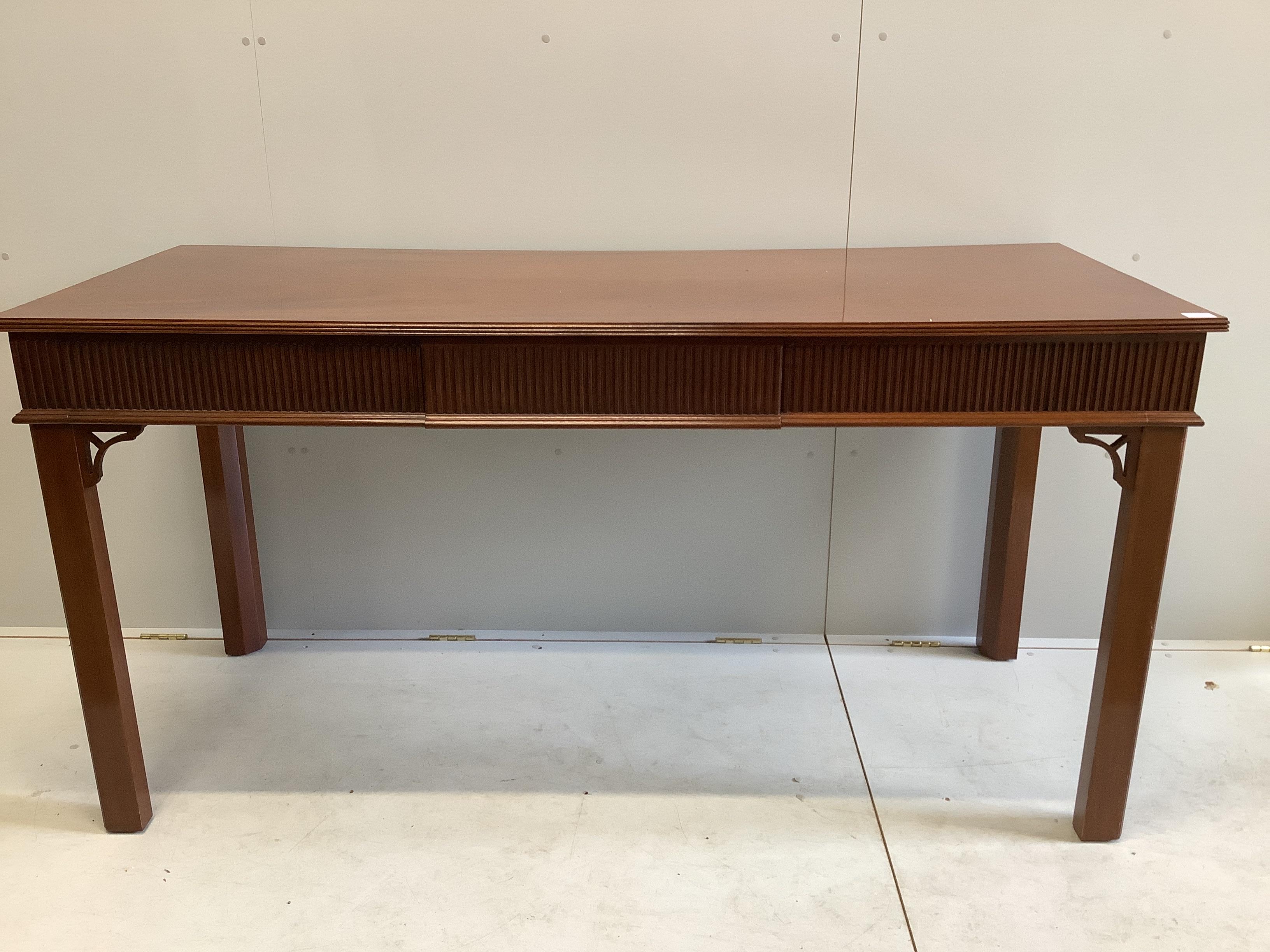 A George III style mahogany serving table, fitted three frieze drawers, the back incorporating two secret drawers, width 183cm, depth 76cm, height 92cm